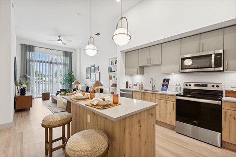 an open kitchen with a large island and a living room